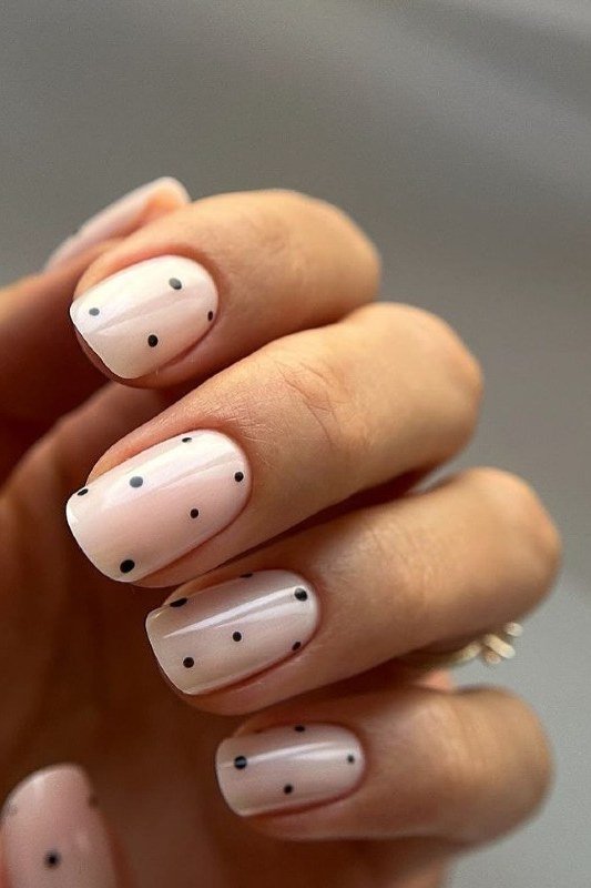 Tiny Black Dots on White Almond minimalist nail art idea for women over 50