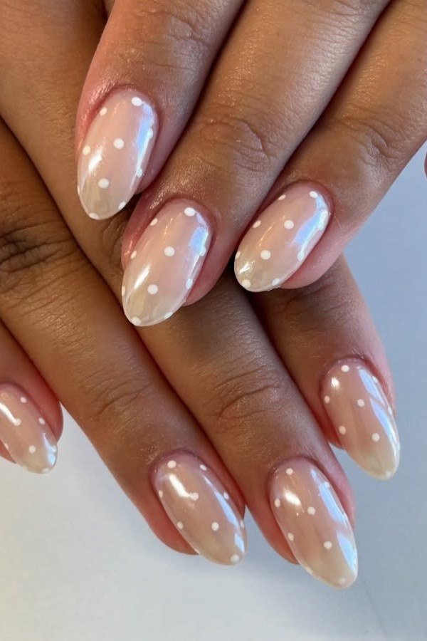 White Polka Dots on Nude Almond minimalist nail art idea for women over 50