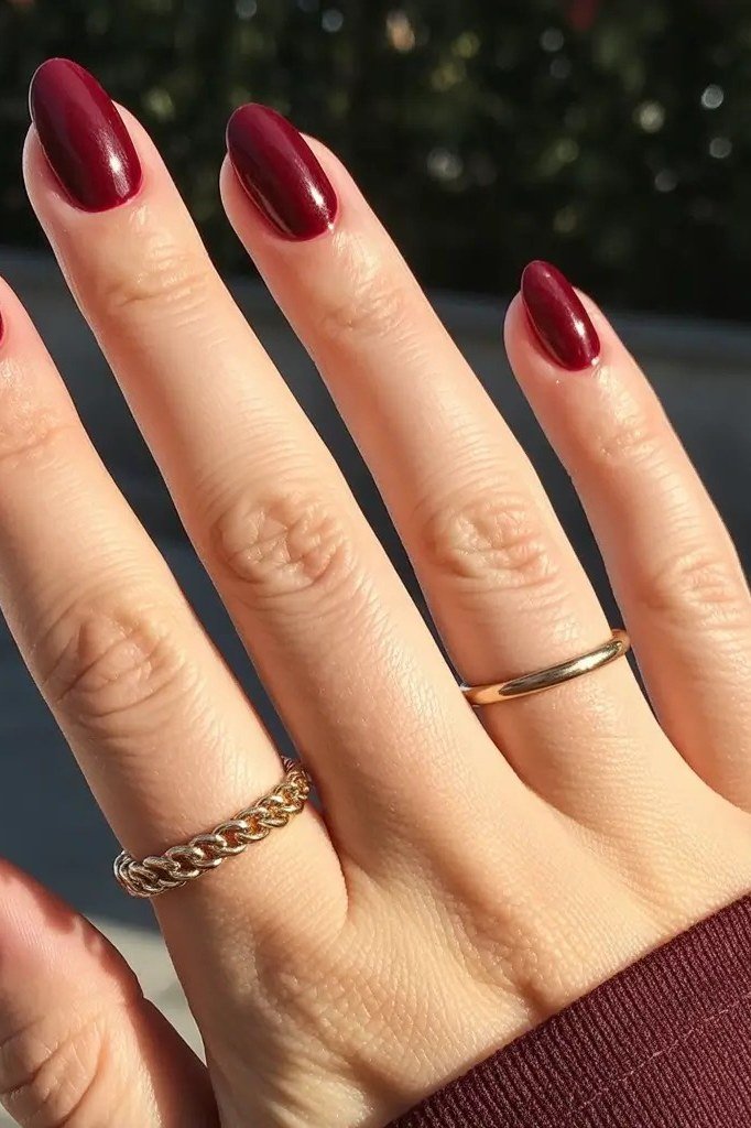 White snowflake on burgundy almond nails for women over 50 - classy winter nail idea 5