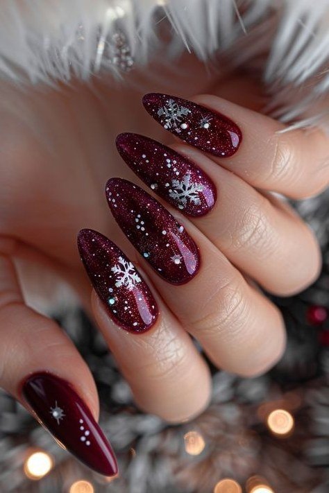 Glittery burgundy with white snowflake, cozy sweater nails for women over 50 - classy winter nail idea 6