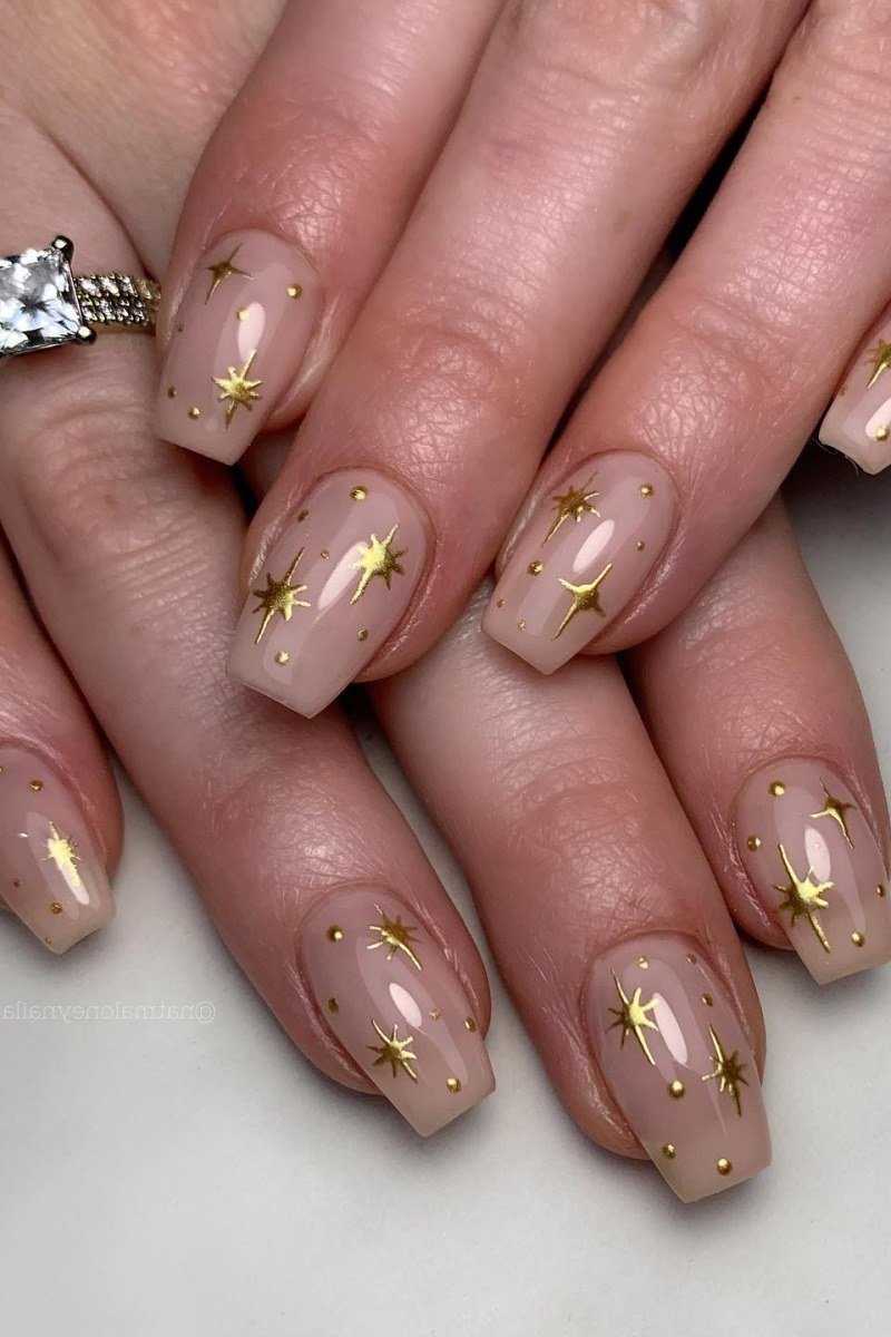 Nude with gold star accents almond nails for women over 50 - classy winter nail idea 17