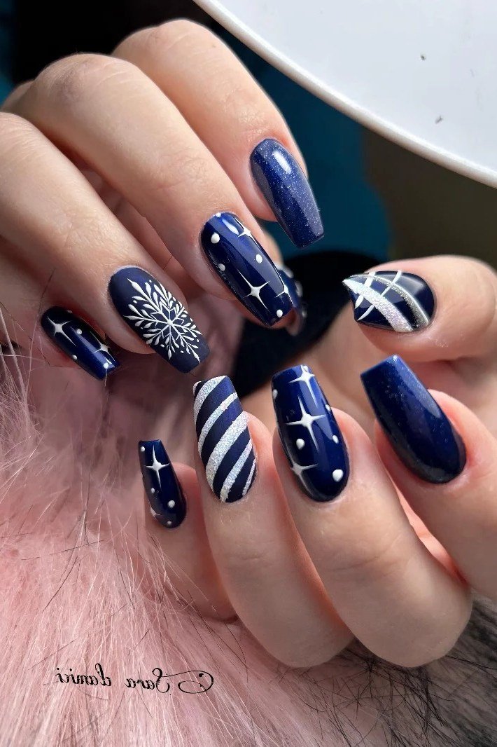 Navy with white snowflake and stripes nails for women over 50 - classy winter nail idea 28