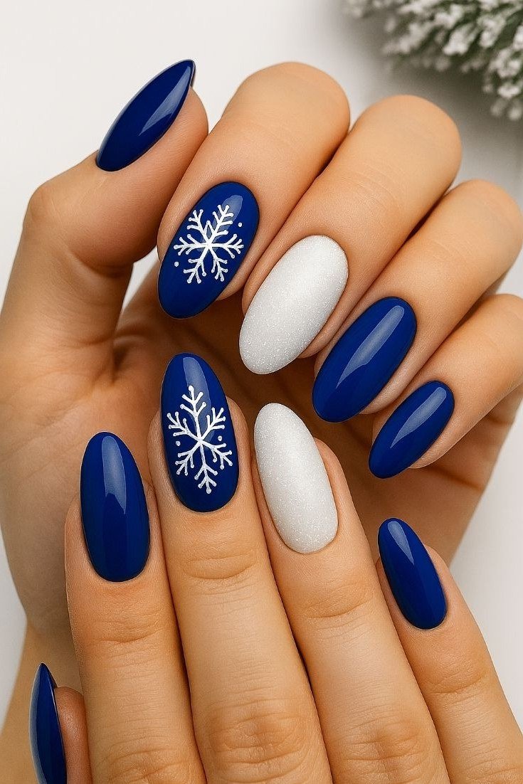 Navy with white snowflake almond nails for women over 50 - classy winter nail idea 29