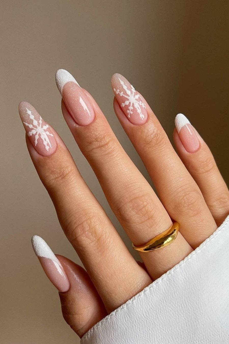 White french with snowflake almond nails for women over 50 - classy winter nail idea 37