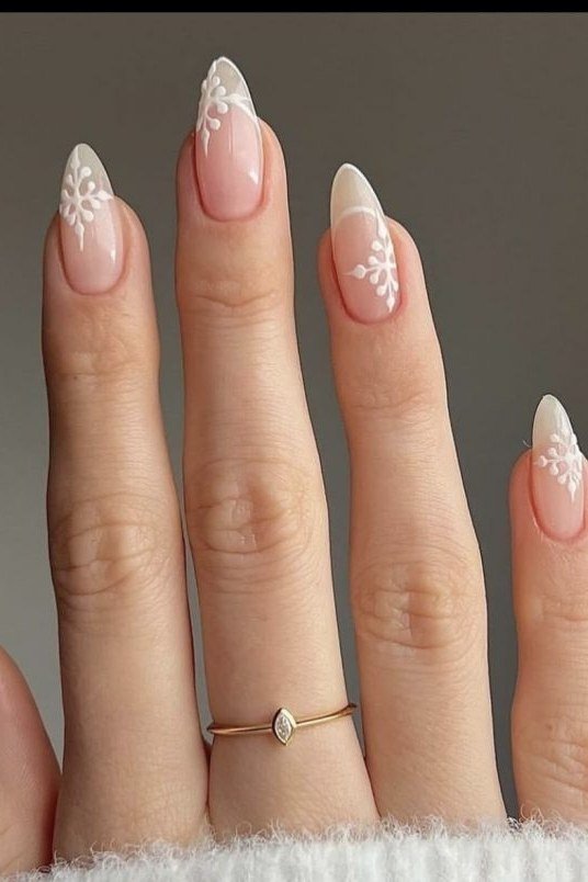 Nude almond with white snowflake nails for women over 50 - classy winter nail idea 38