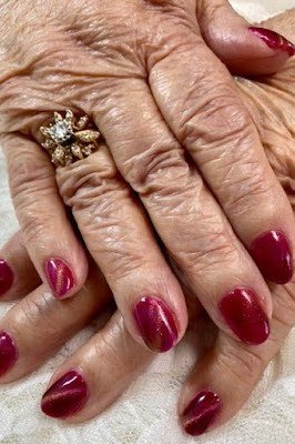 Red Almonds on Graceful Hands - nail color for women over 60