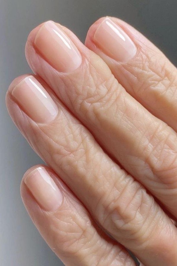 Closeup of natural pink almond nails - simple natural nail idea for women over 60