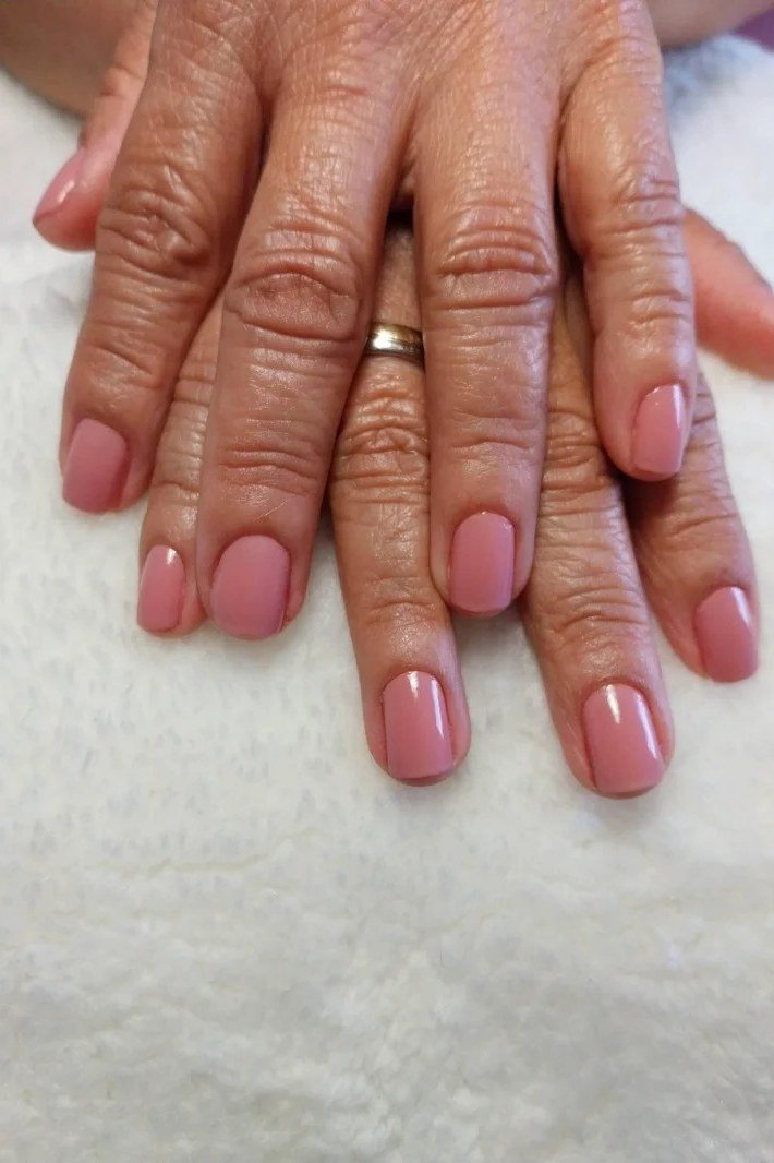 dusty rose short squoval nails on dark mature hands