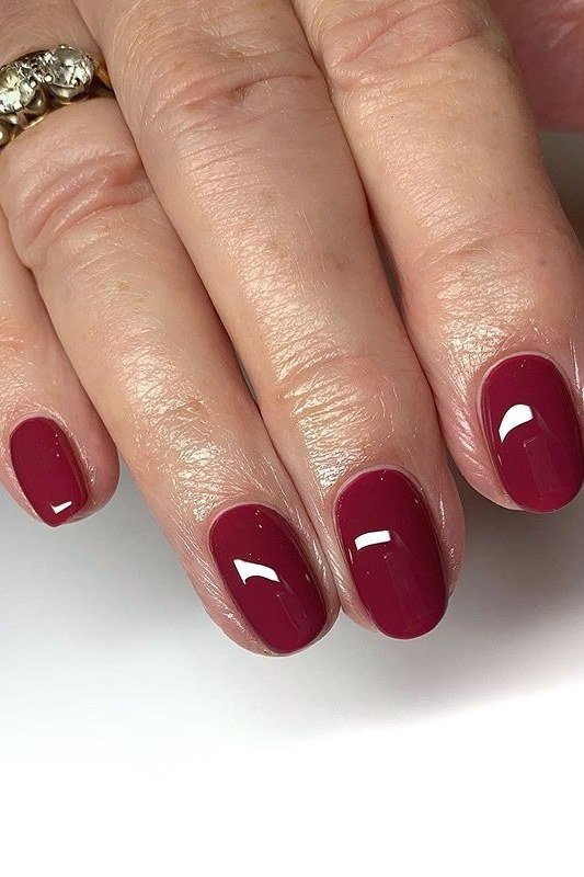 classic red glossy almond medium nails, side view