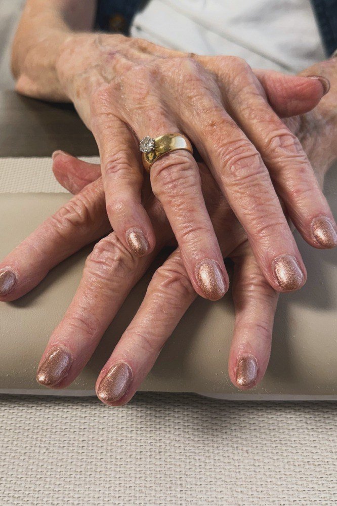 rose-gold metallic shimmer short nails on crossed hands