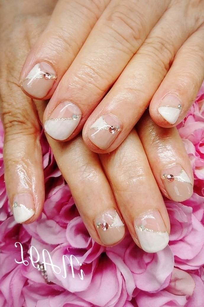 white french tips short almond with rhinestone accents on pink flowers