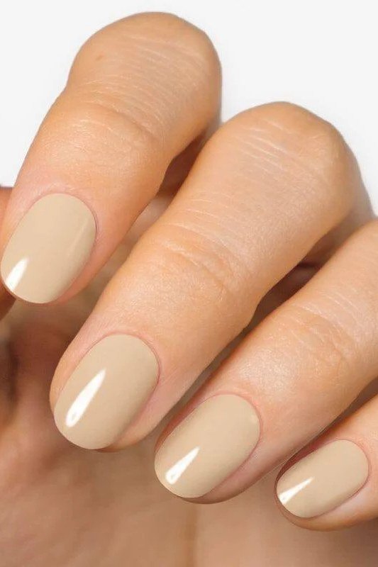 Glossy caramel beige squoval nails close up - caramel nude nail idea for women over 50
