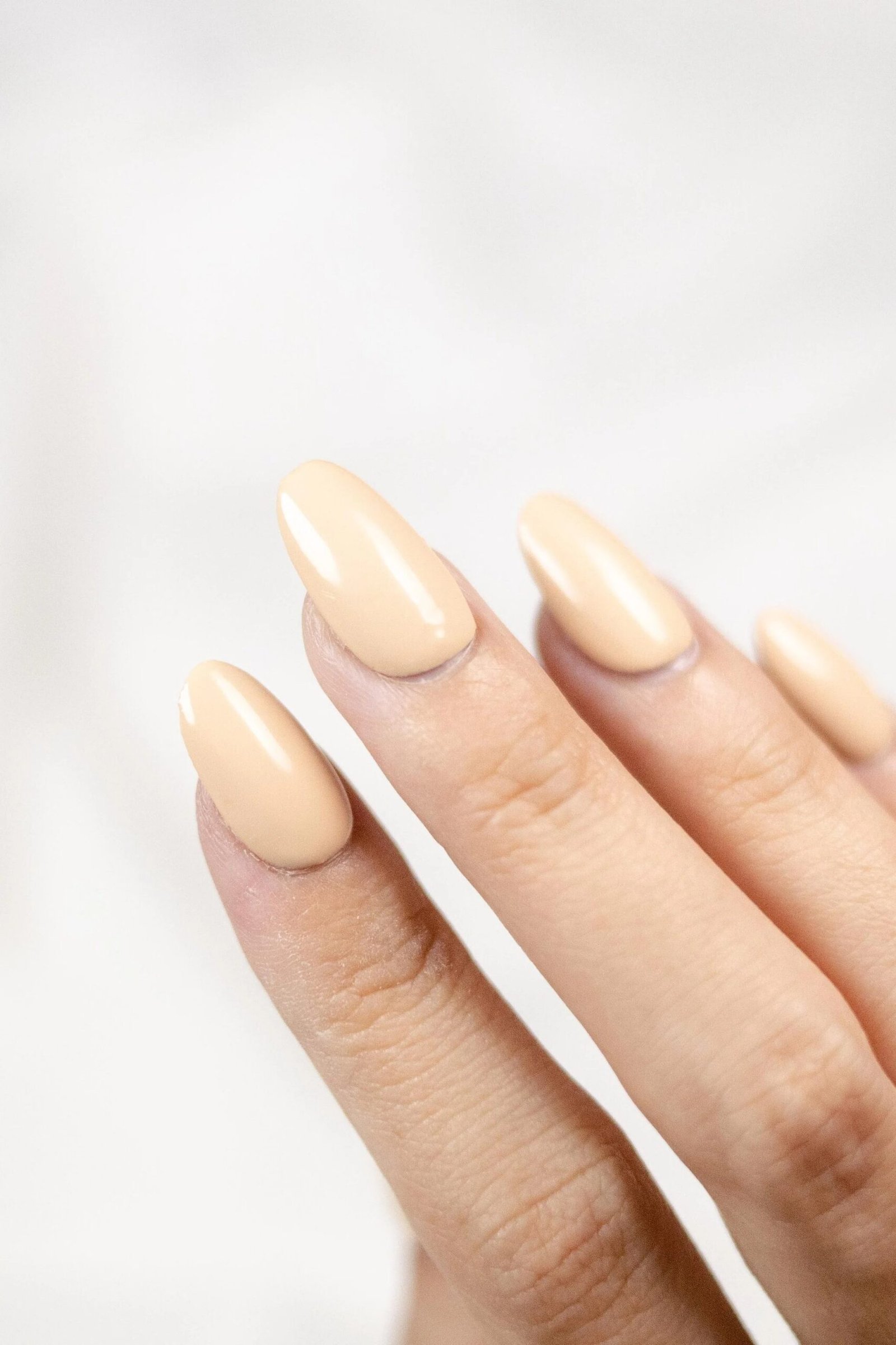 Minimalist beige nude almond nails - caramel nude nail idea for women over 50