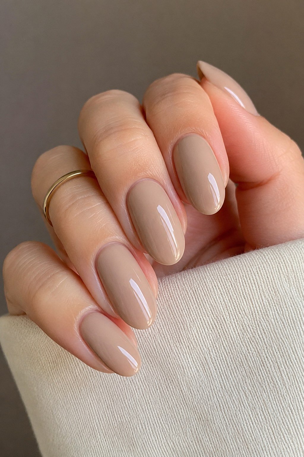 Taupe caramel almond nails with a gold ring - caramel nude nail idea for women over 50