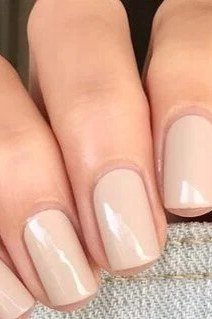 High-shine creamy nude squoval nails close up - caramel nude nail idea for women over 50