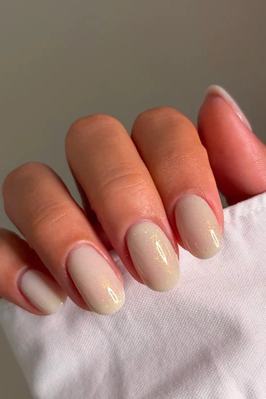 Blush caramel almond nails with a soft glow - caramel nude nail idea for women over 50