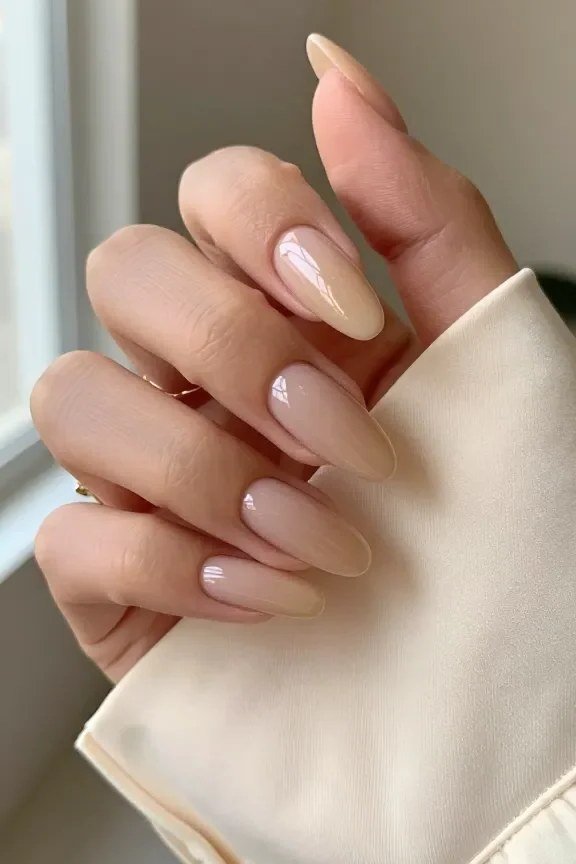 Sheer caramel almond nails with a cream sleeve - caramel nude nail idea for women over 50