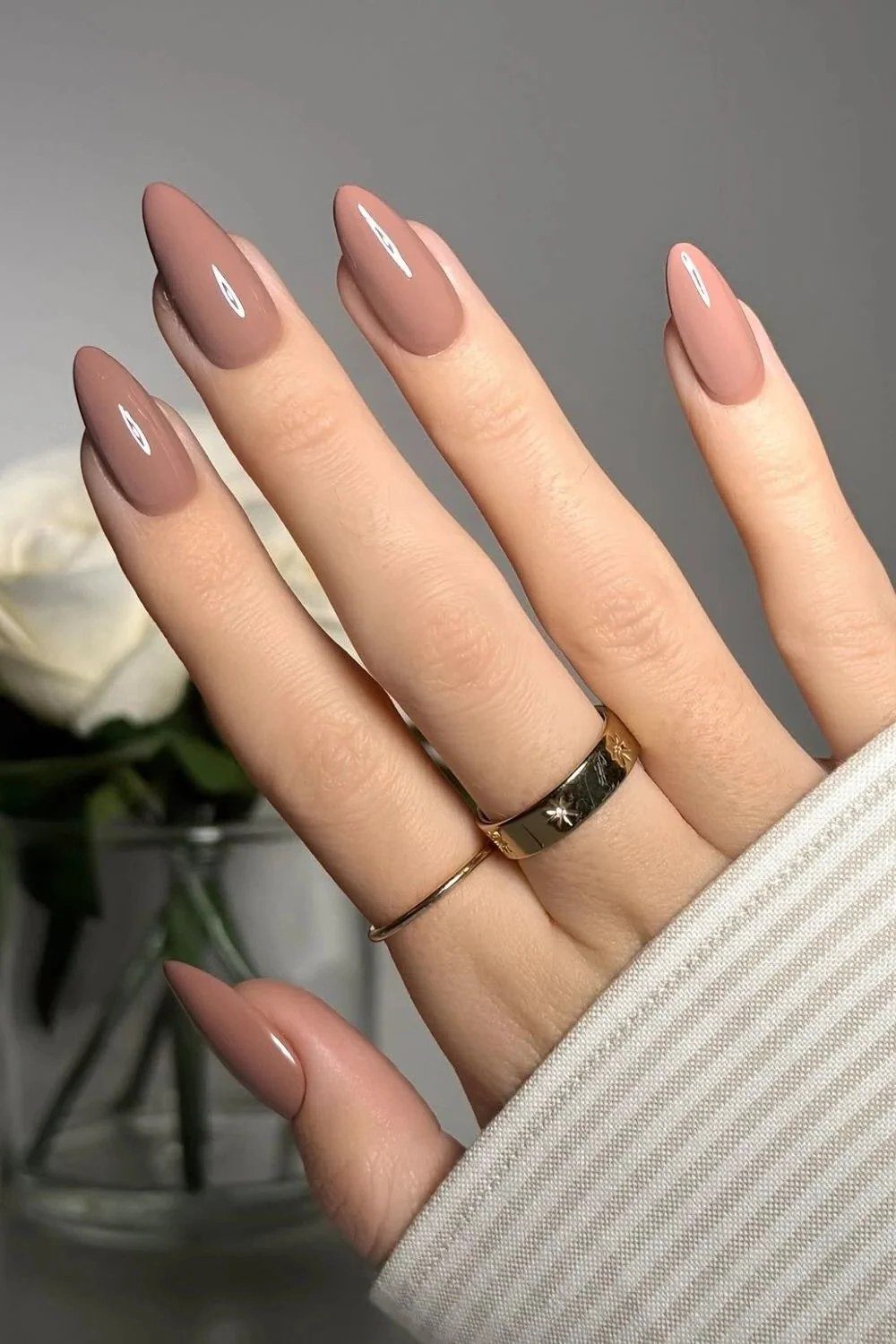 Dusty mauve almond nails with gold rings - caramel nude nail idea for women over 50