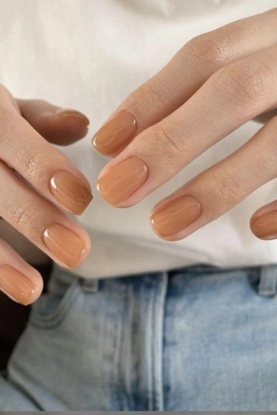Caramel nude squoval nails on both hands - caramel nude nail idea for women over 50