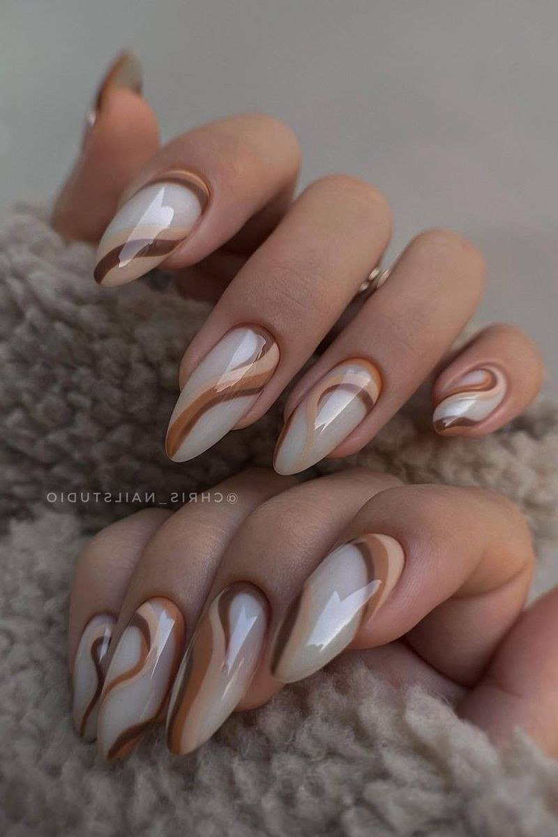 Caramel and white swirl nail art on almonds - caramel nude nail idea for women over 50