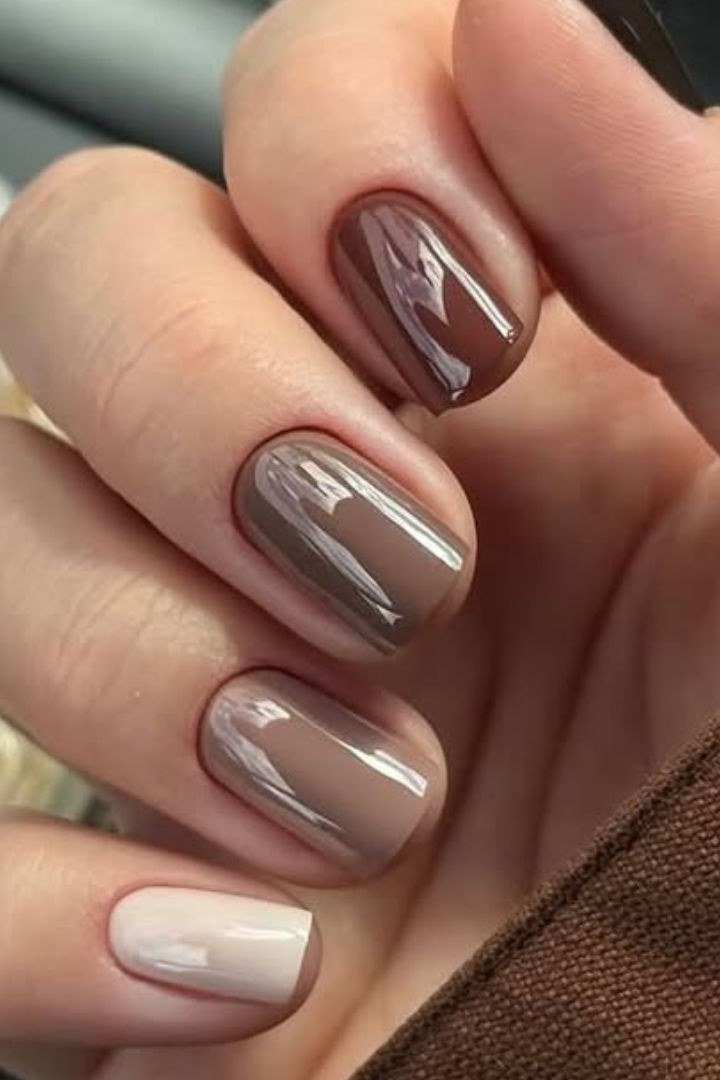 Taupe caramel nails holding a coffee cup - caramel nude nail idea for women over 50