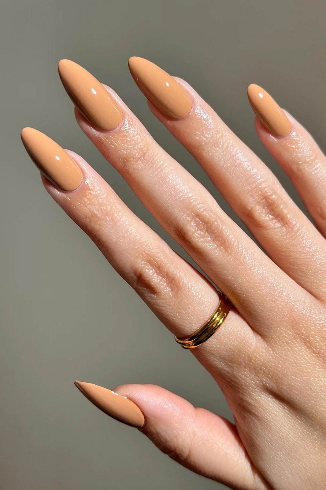 Butterscotch caramel almond nails with gold ring - caramel nude nail idea for women over 50