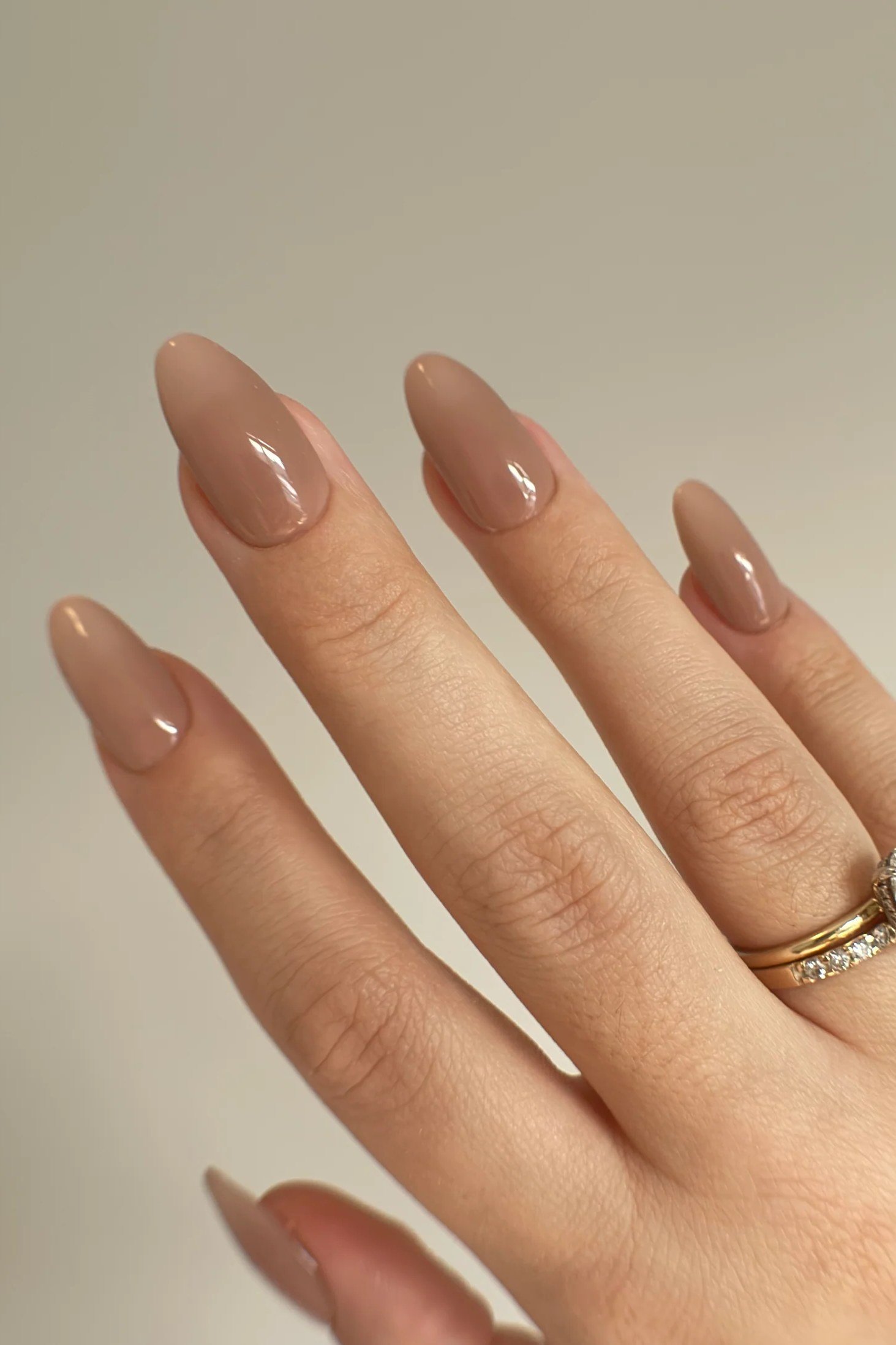 Taupe nude almond nails with gold rings - caramel nude nail idea for women over 50