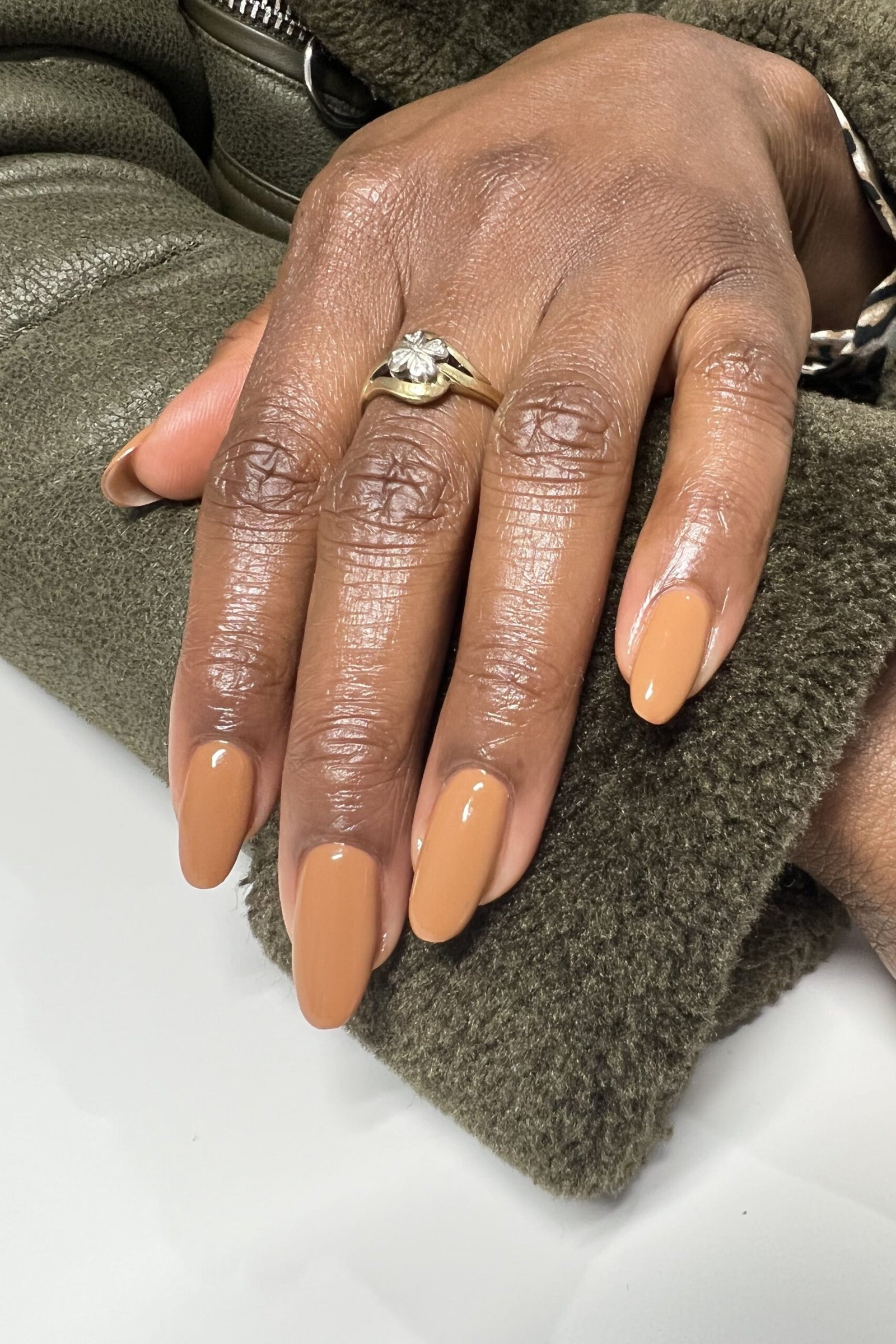 Caramel nude almond nails on deep skin with ring - caramel nude nail idea for women over 50