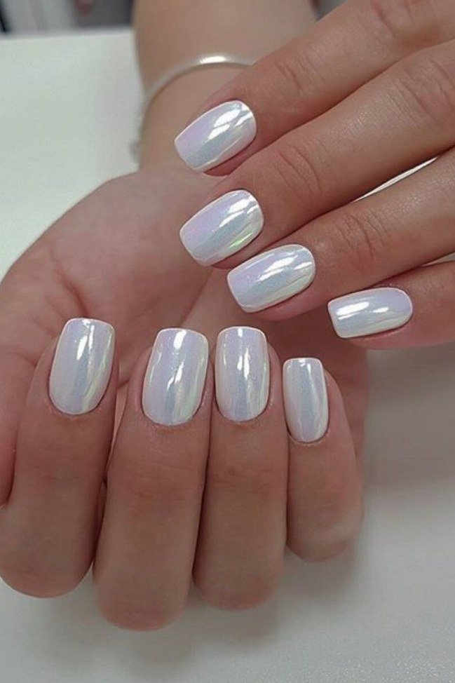 Short square nails in icy blue-white pearl chrome for women over 50