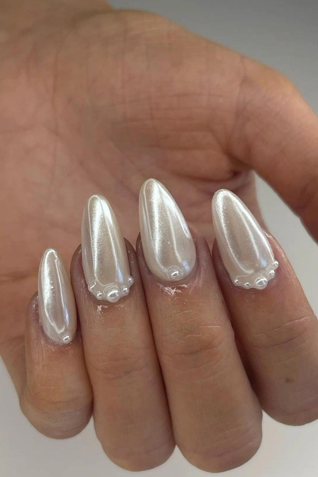Stiletto nails in high-shine pearl chrome for women over 50