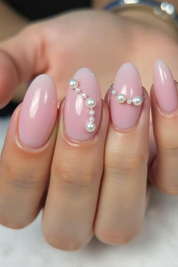 Pink pearl almond nails with pearl bead arcs for women over 50