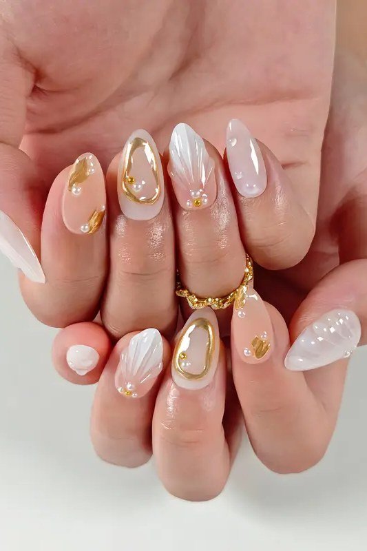 Pearl nails with gold swirl art for women over 50
