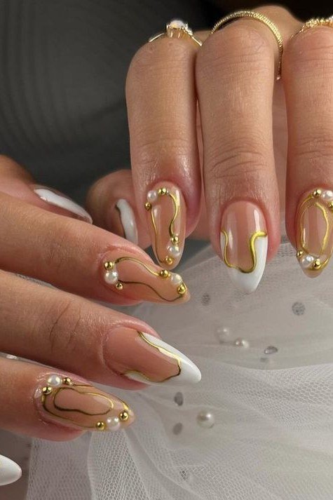 Pearl nails with gold swirls and pearl dots for women over 50