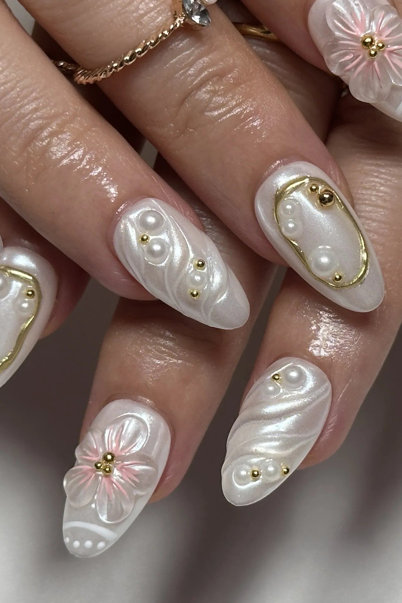 Pearl nails with gold line and flower art for women over 50