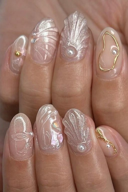 Pearl nails with gold line art and shell details for women over 50