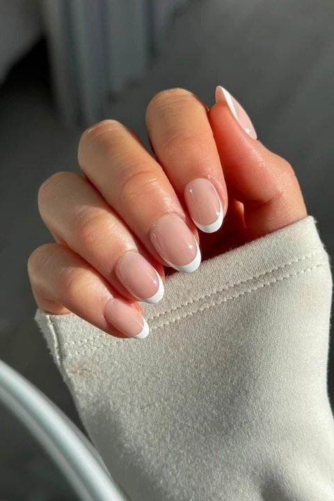 Almond nude french tip, sweater sleeve - flattering nail idea for women over 50