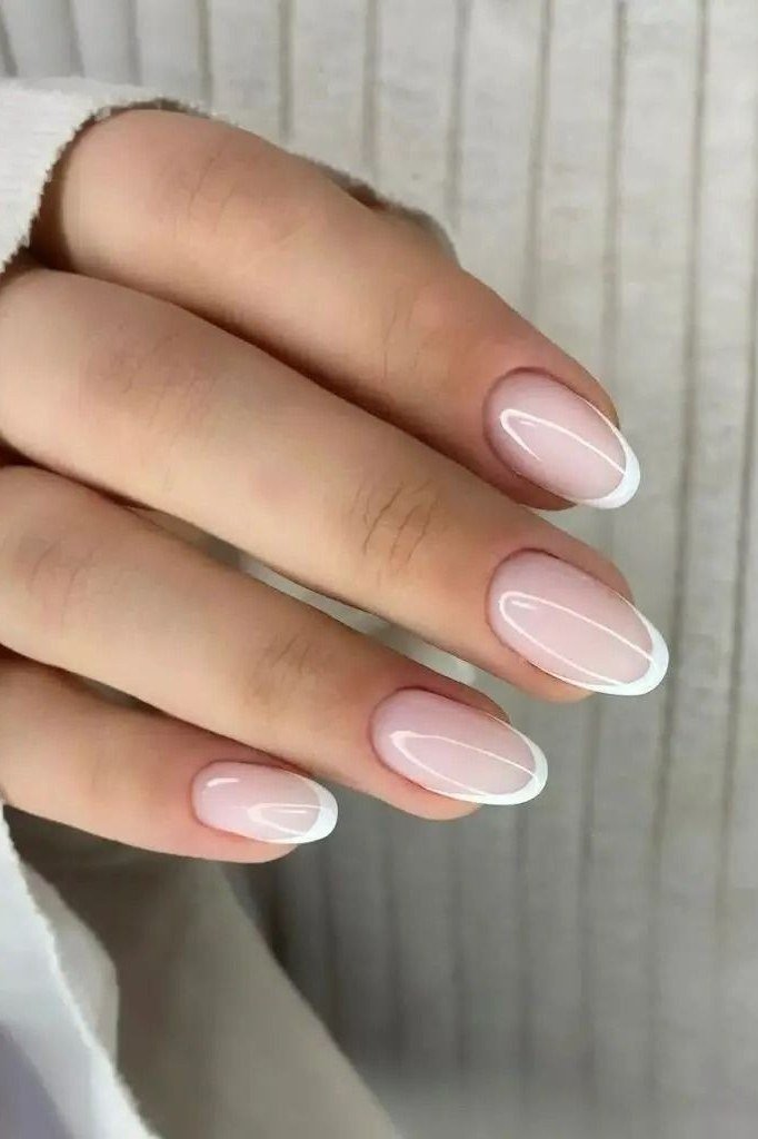 Short oval french tip, sweater - flattering nail idea for women over 50