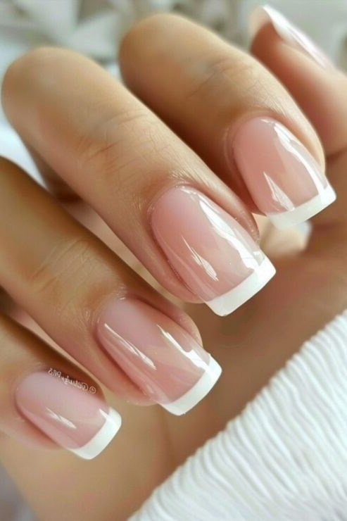 Glossy nude french almond closeup - flattering nail idea for women over 50