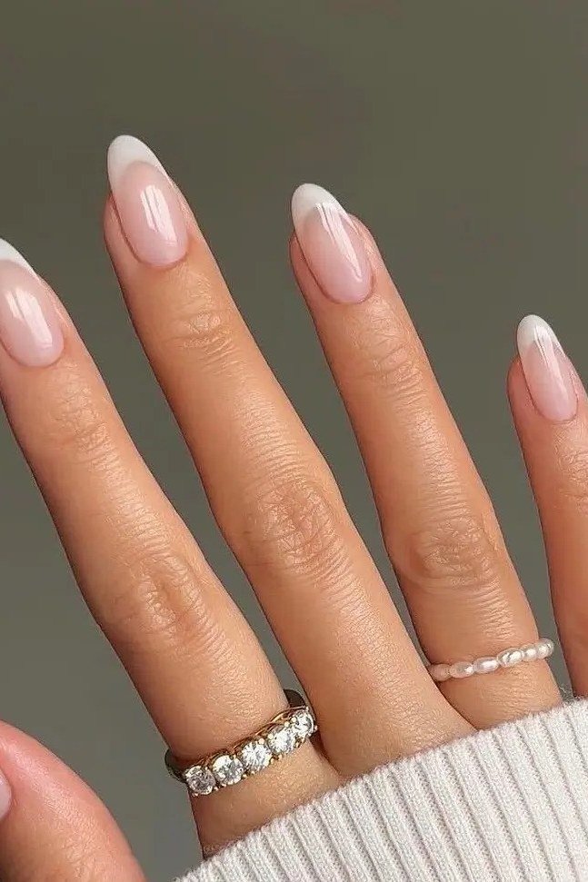 Almond nude french tip with rings - flattering nail idea for women over 50