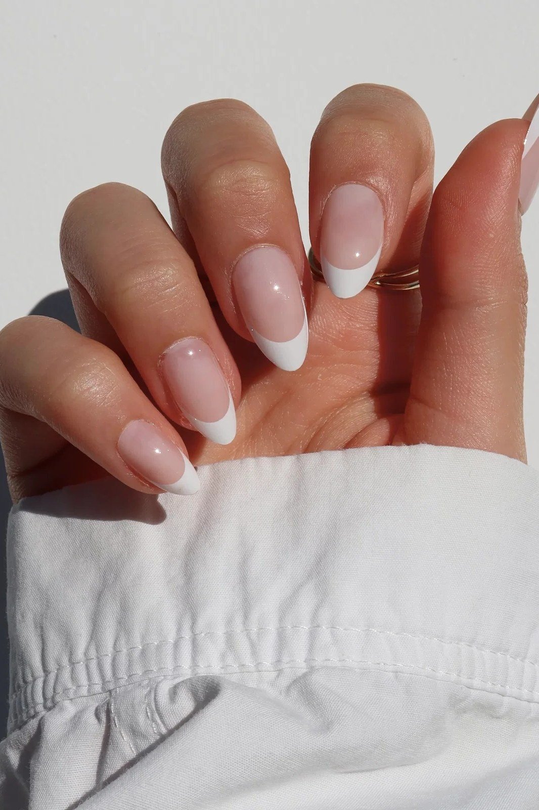 Almond french tip, white cuff sleeve - flattering nail idea for women over 50