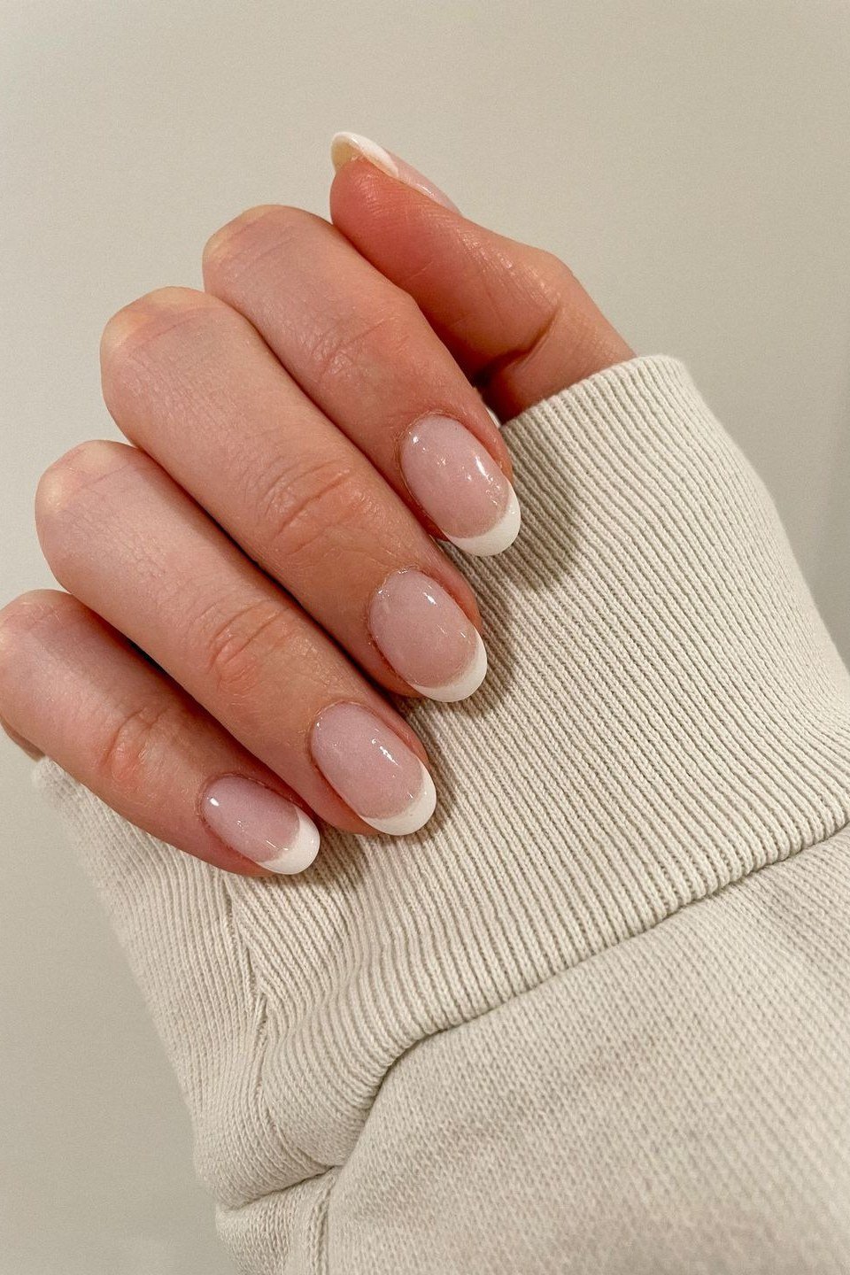 Almond nude french tip with rings, sunlit - flattering nail idea for women over 50