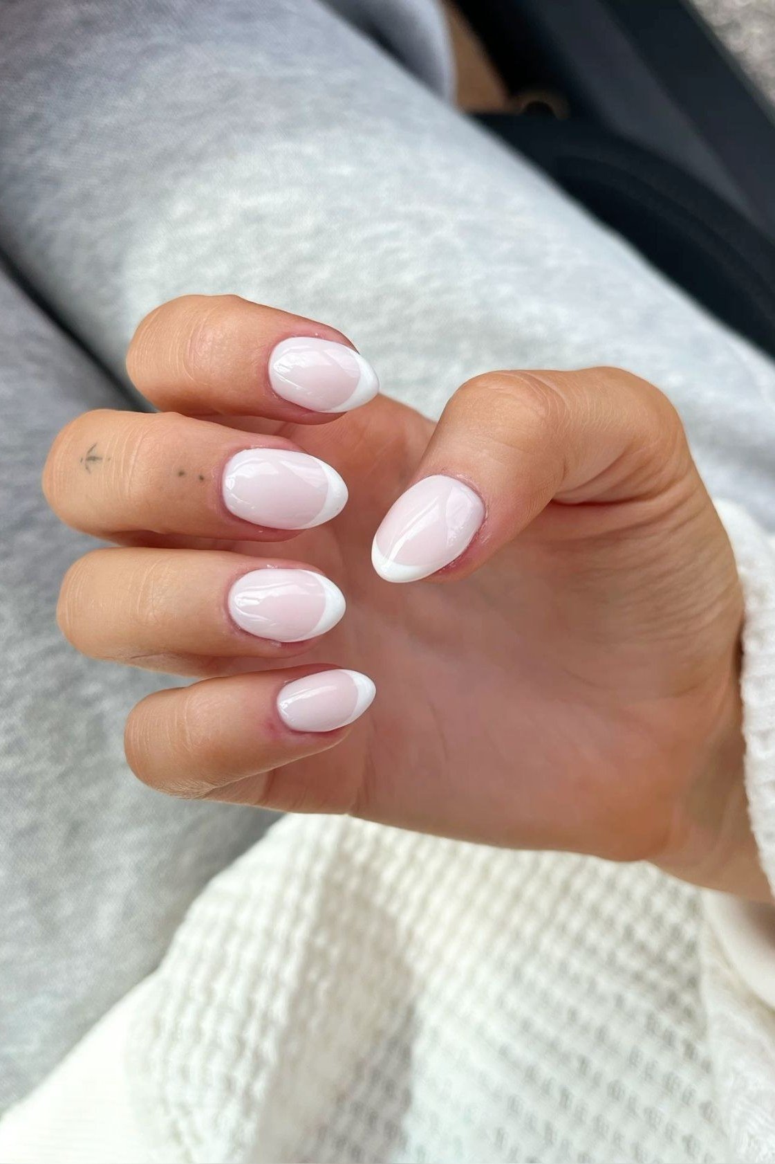 Milky white oval plain nails - flattering nail idea for women over 50