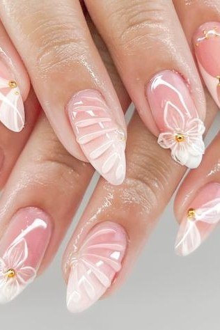 Almond french with white floral art - flattering nail idea for women over 50