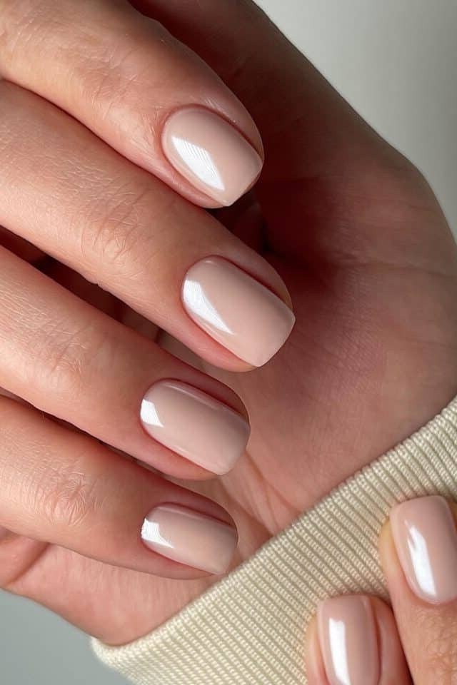 Pearly nude oval, sweater cuff - flattering nail idea for women over 50