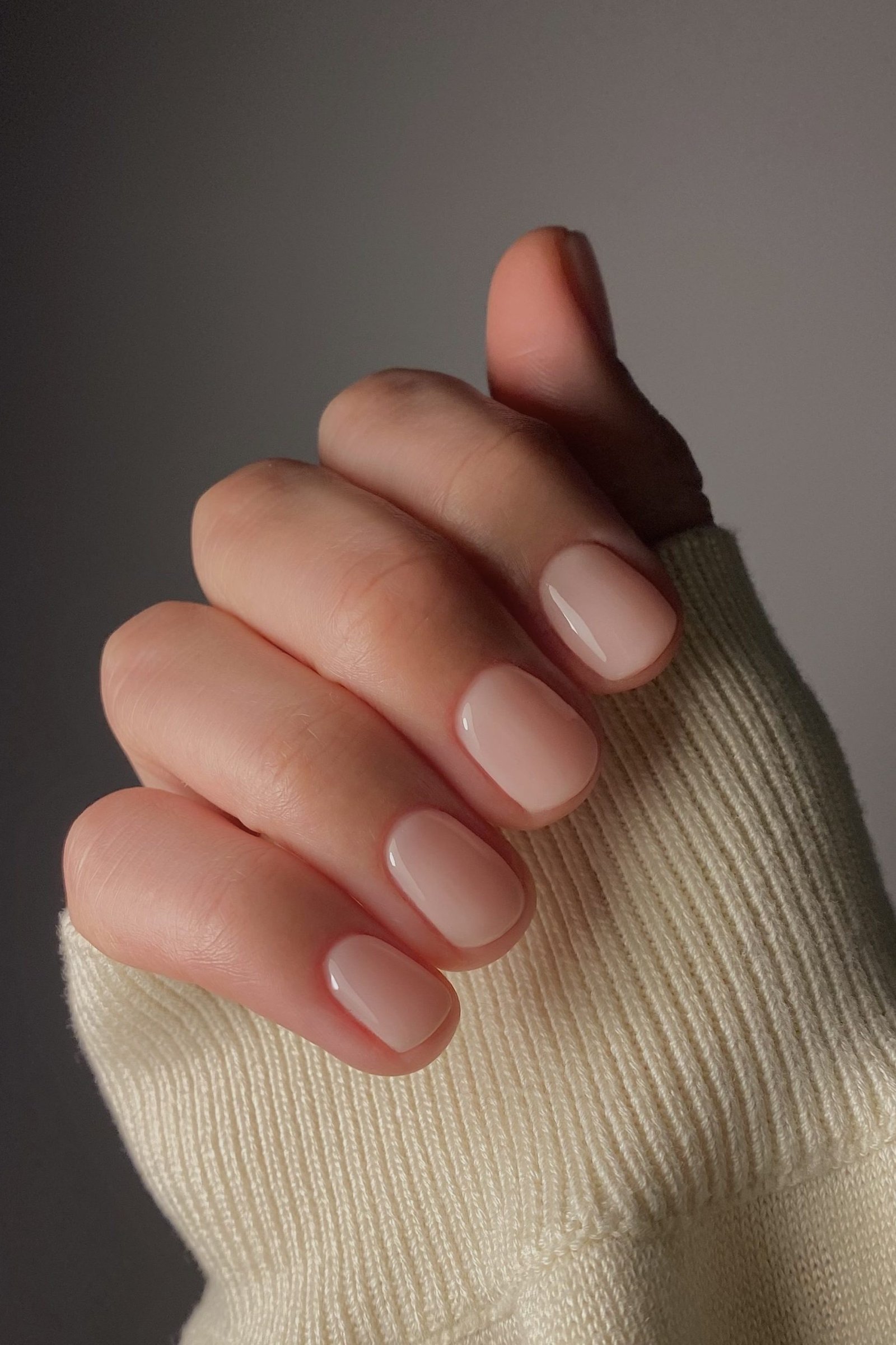 Short nude square, sweater sleeve - flattering nail idea for women over 50