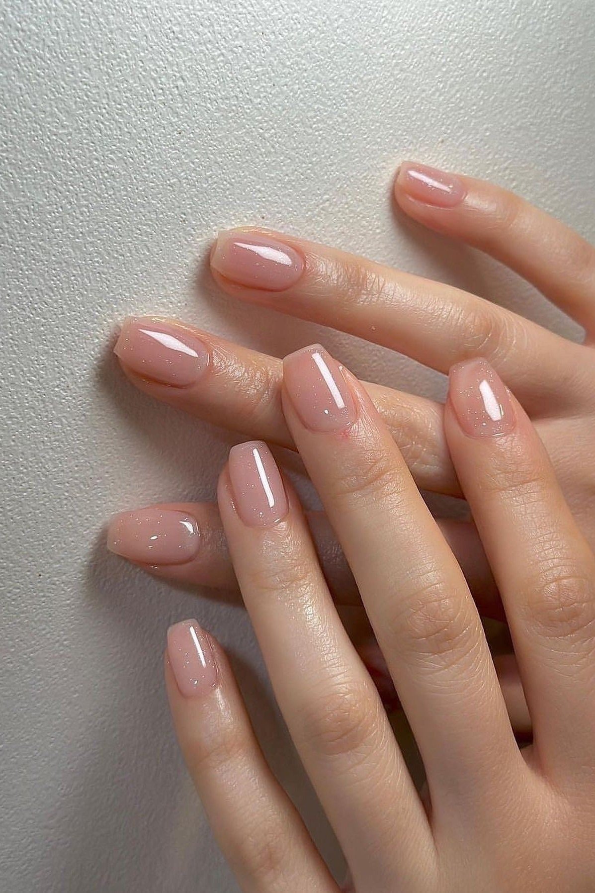 Nude oval on white background, both hands - flattering nail idea for women over 50