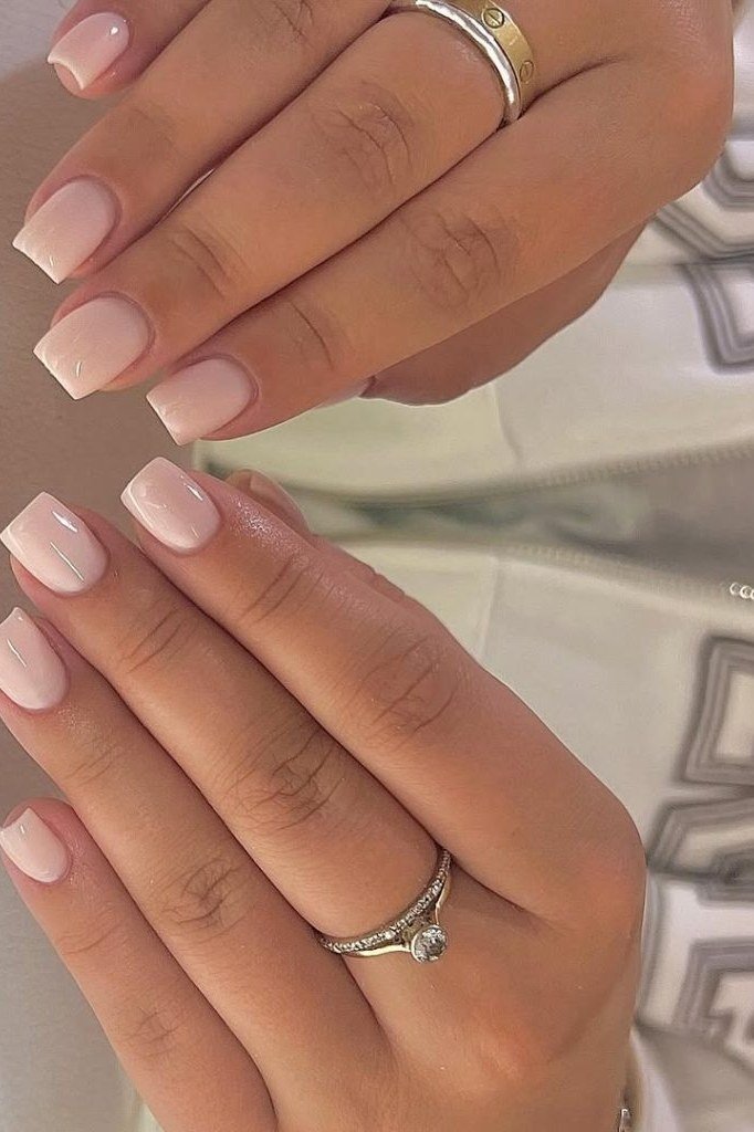 Short square french tip, two hands with rings - flattering nail idea for women over 50