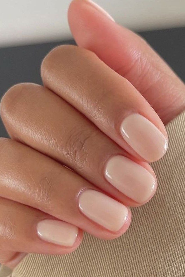 Almond milky nude nails side view with beige sleeve for women over 50