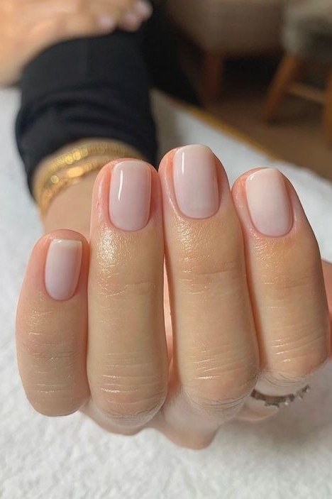 Short squoval milky nude nails glossy manicure for women over 50