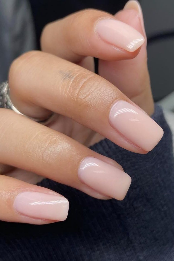 Squoval milky pink nails with navy sweater for women over 50
